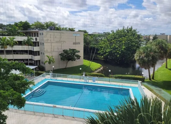 a view of a swimming pool with a yard