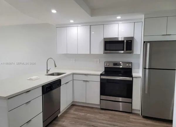 a kitchen with a sink stainless steel appliances and cabinets