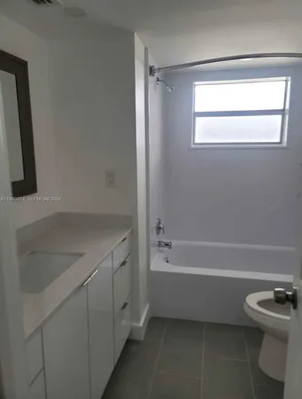 a bathroom with a bathtub sink and toilet