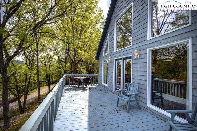 a view of balcony with chairs and wooden fence