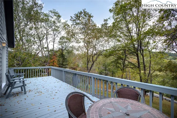 a view of balcony with furniture and trees