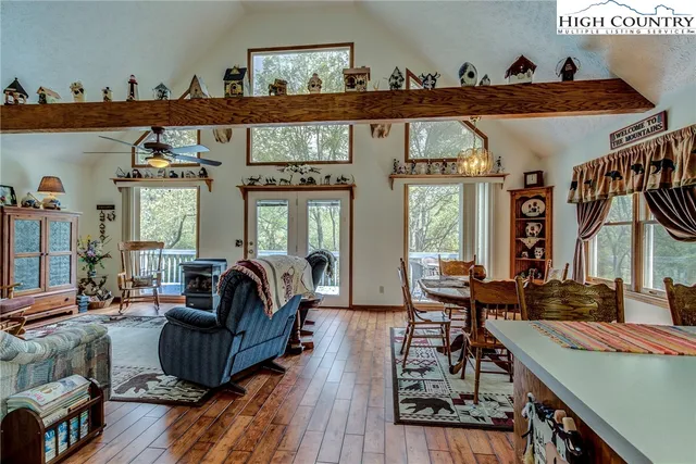 a living room with furniture a rug and a large window