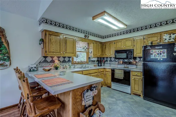 a kitchen with a table and chairs in it