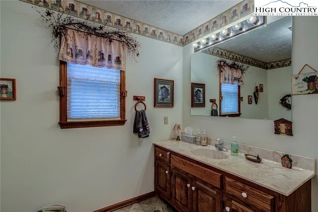 a bathroom with a sink vanity and a mirror