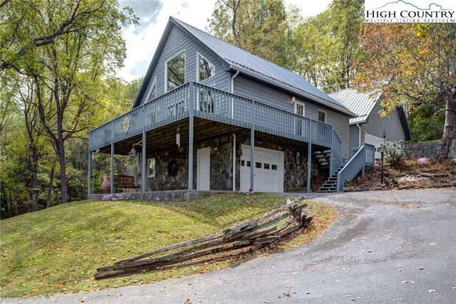 a view of a house with a yard balcony and tree
