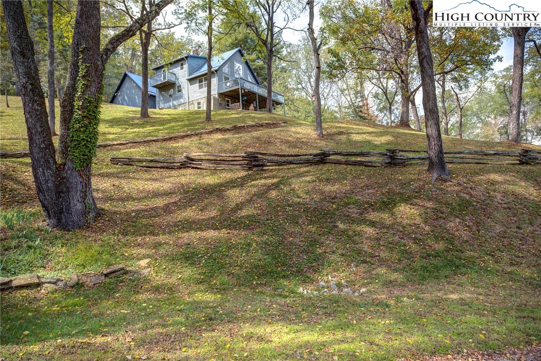 2164 River Bend Road Mouth Of Wilson, VA 24363 - Photo 45 of 50 a front view of a house with a yard and trees