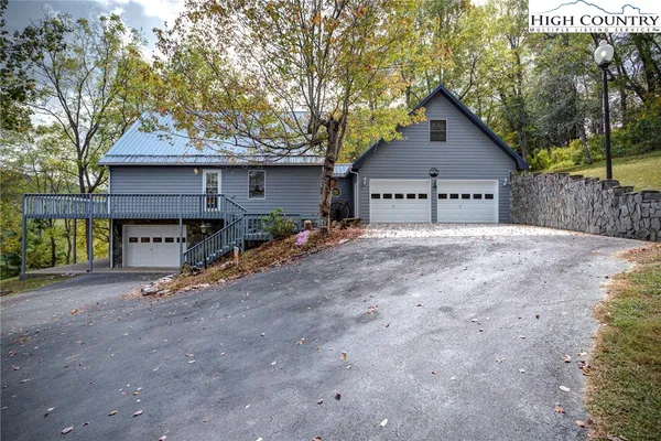 a view of a house with wooden fence next to a road