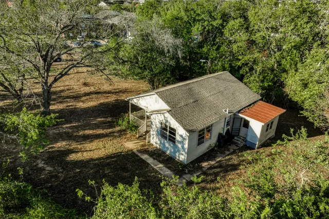 an aerial view of a house with a yard