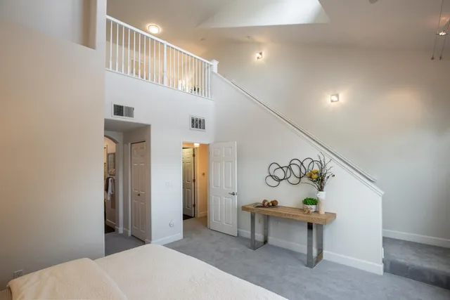 a bedroom with a bed and a table