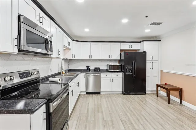 a kitchen with a refrigerator stove and microwave