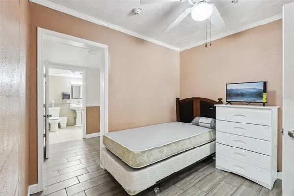 a bedroom with a bed and a view of bathroom