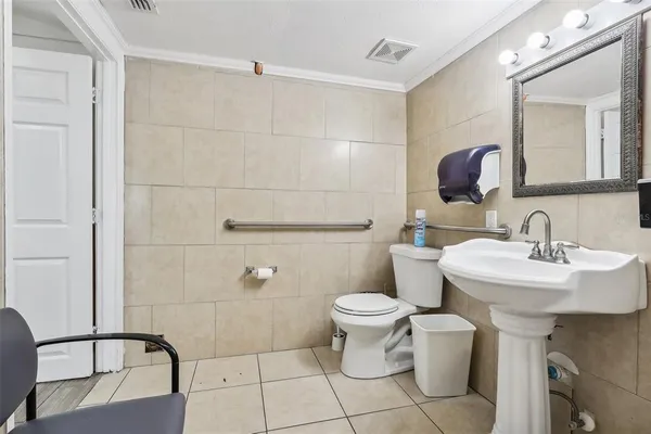 a bathroom with a sink toilet and mirror