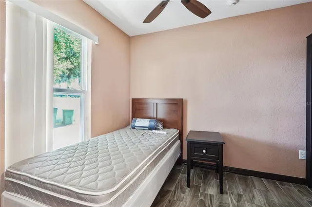 a bed sitting in a bedroom next to a window