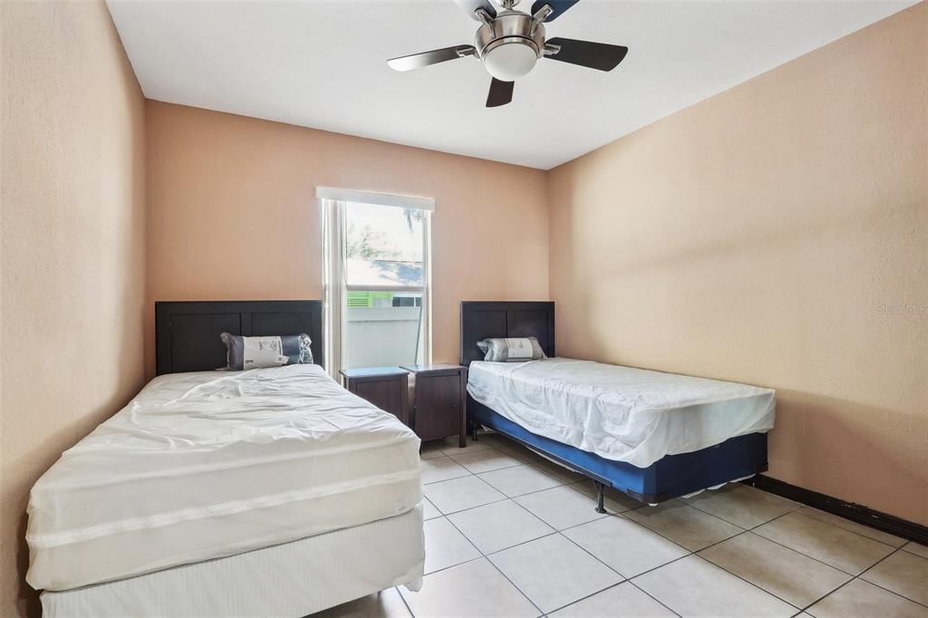 201 Rosefield Avenue Leesburg, FL 34748 - Photo 26 of 43 a bedroom with two beds and painting on the wall