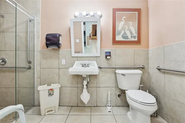 a white toilet sitting next to a bathroom sink