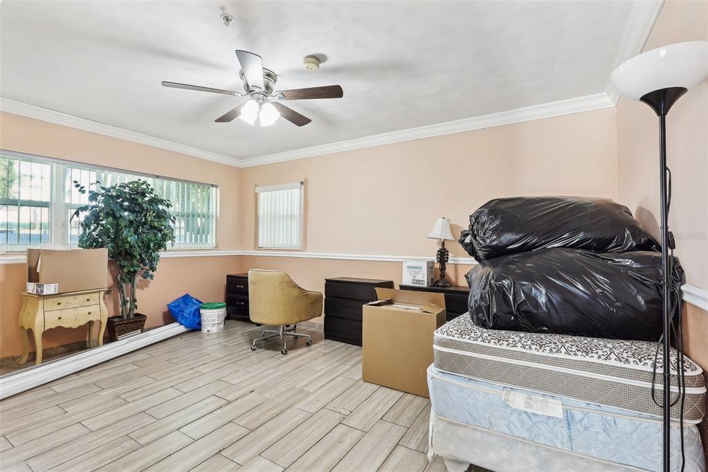 201 Rosefield Avenue Leesburg, FL 34748 - Photo 29 of 43 a living room with furniture and a chandelier