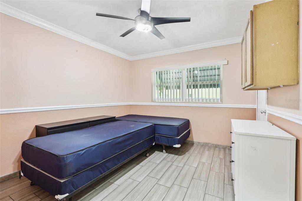 201 Rosefield Avenue Leesburg, FL 34748 - Photo 32 of 43 a living room with a bed furniture and a window