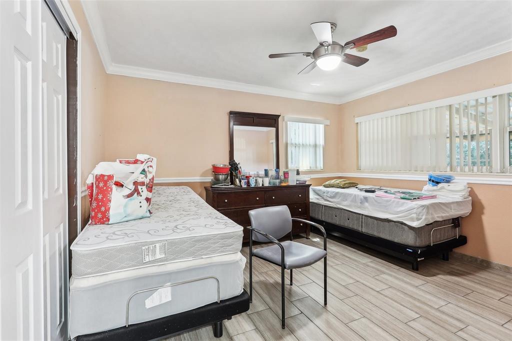 201 Rosefield Avenue Leesburg, FL 34748 - Photo 33 of 43 a bedroom with a bed and a chandelier