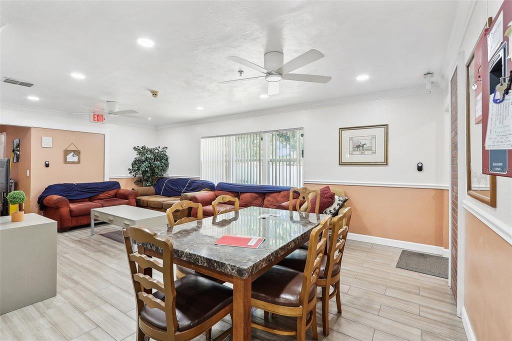 201 Rosefield Avenue Leesburg, FL 34748 - Photo 8 of 43 a view of a dining room with furniture and wooden floor