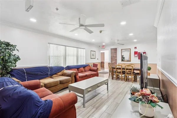 a living room with furniture and kitchen view