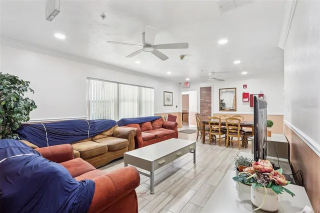 a living room with furniture and kitchen view