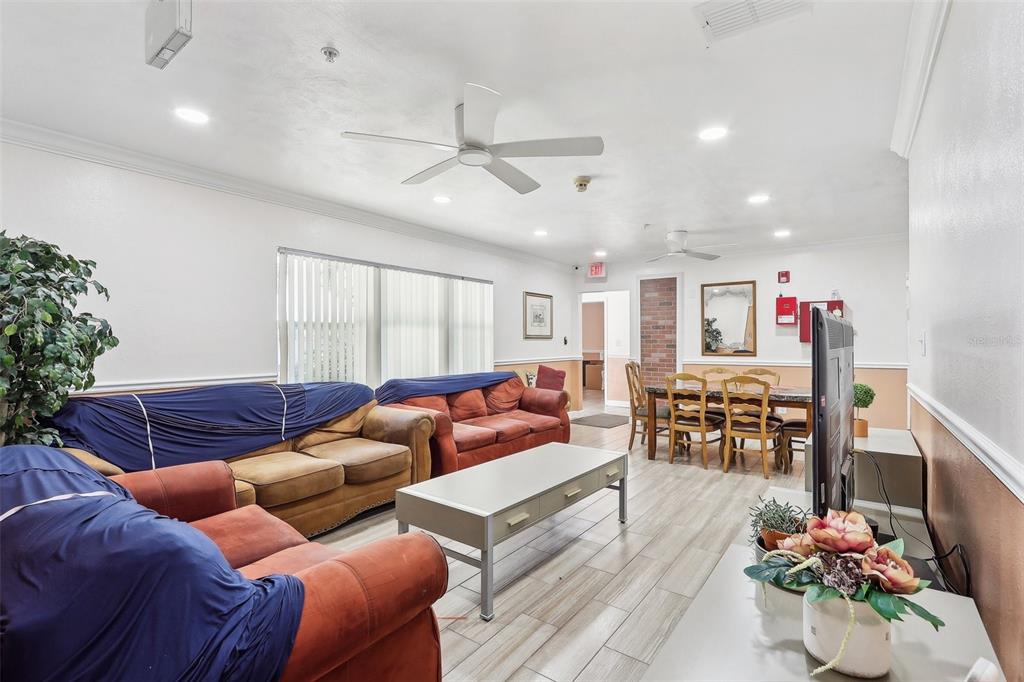 201 Rosefield Avenue Leesburg, FL 34748 - Photo 9 of 43 a living room with furniture and kitchen view