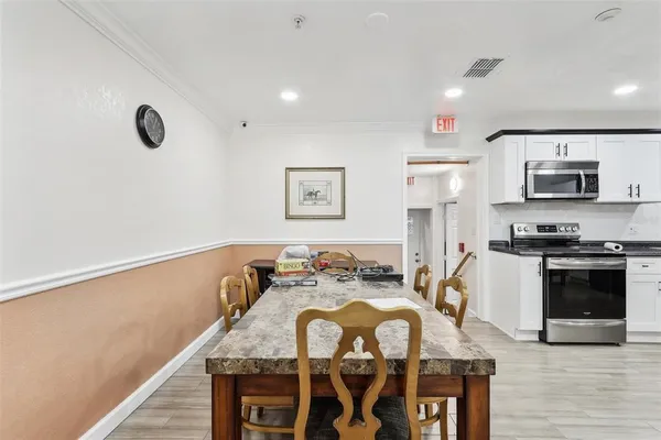 a view of kitchen and dining room with wooden floor