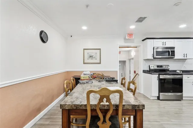 a view of kitchen and dining room with wooden floor