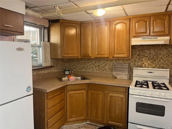 a kitchen with stainless steel appliances a stove a refrigerator and a sink