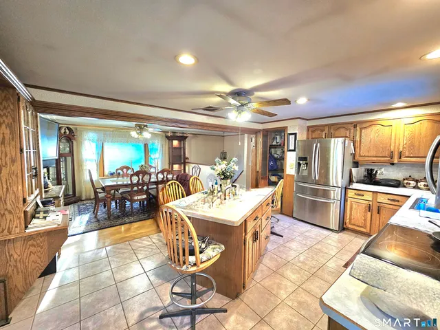 a view of a dining room with furniture a kitchen and chandelier