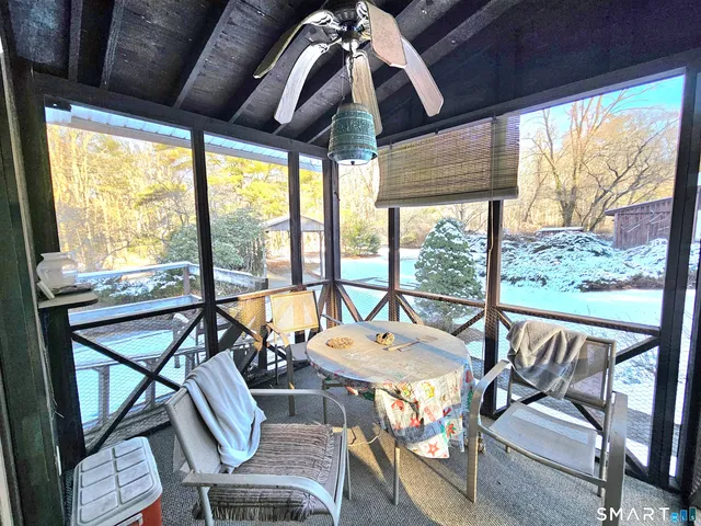 a balcony with furniture and large windows