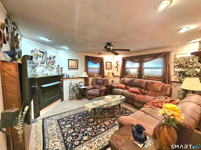 a living room with furniture a rug and a flat screen tv