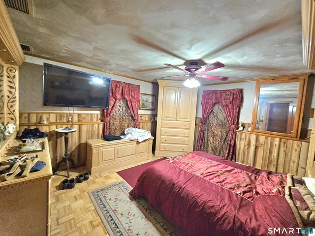 a bedroom with a bed and a flat screen tv