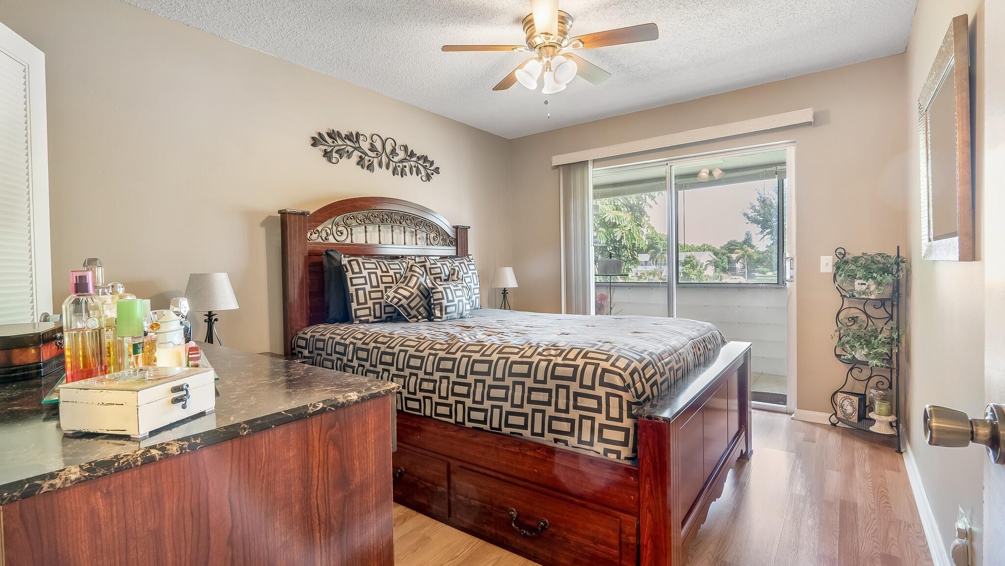 239 Windsor K West Palm Beach, FL 33417 - Photo 4 of 11 a bedroom with a bed and a mirror on the dresser