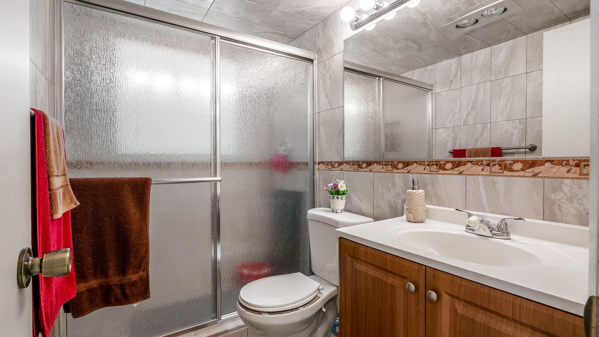 239 Windsor K West Palm Beach, FL 33417 - Photo 6 of 11 a bathroom with a sink toilet and shower