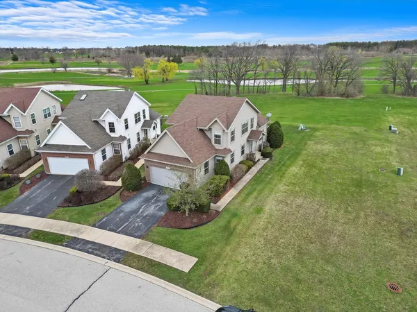 an aerial view of a house with big yard