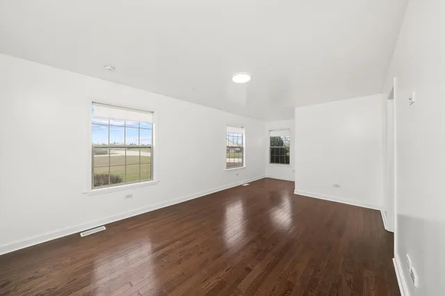 an empty room with wooden floor