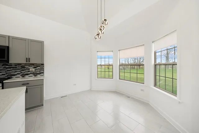 a view of kitchen with stainless steel appliances a refrigerator and a stove
