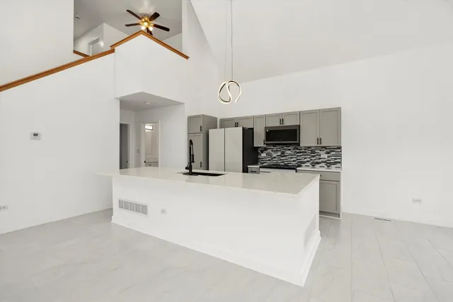 a kitchen with refrigerator a sink and cabinets