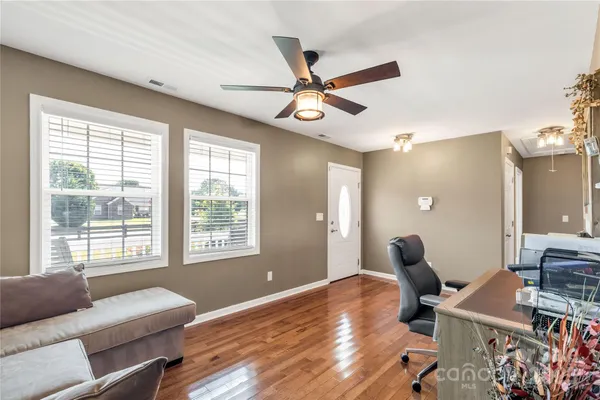 a kitchen with stainless steel appliances granite countertop a sink stove refrigerator and cabinets