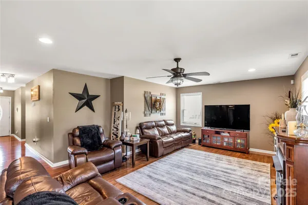 a living room with furniture a window and a flat screen tv