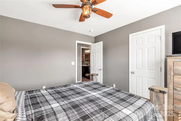 a bedroom with a bed and a fireplace