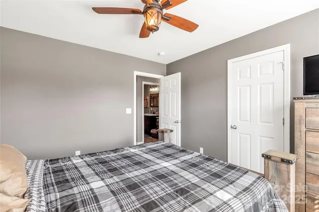 a bedroom with a bed and a fireplace