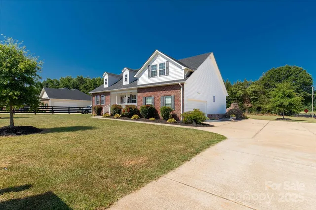 a front view of a house with yard and green space