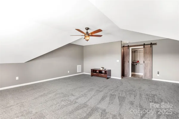 a bathroom with a granite countertop toilet sink and mirror