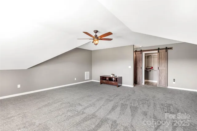 a bathroom with a granite countertop toilet sink and mirror