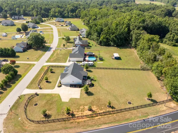 an aerial view of a house with a swimming pool