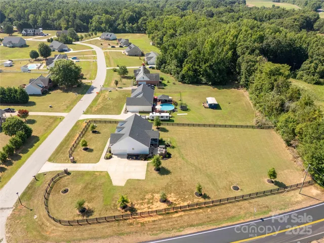 an aerial view of a house with a swimming pool