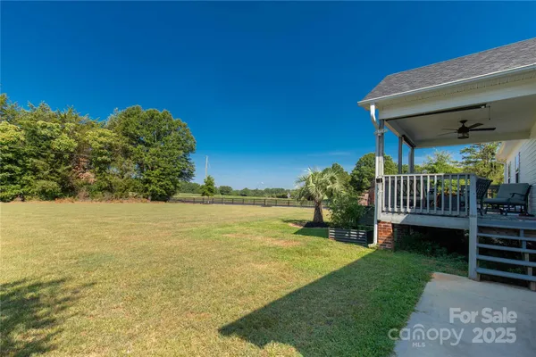 a front view of house with outdoor space and trees all around