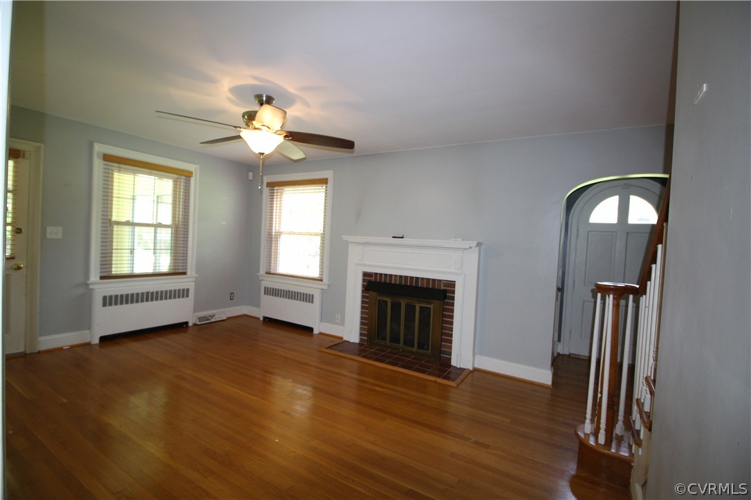 11268 Hanover Courthouse Road Hanover, VA 23069 - Photo 3 of 21 an empty room with windows fireplace and a kitchen